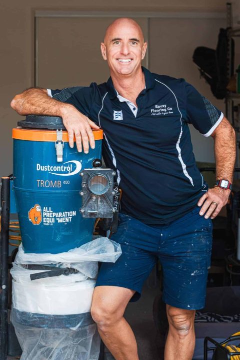 Photo of Tikm McGary on the job laying Epoxy Flake flooring